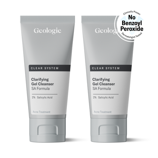 Two tubes of Geologie Clear System - Clarifying Gel Cleanser with 2% salicylic acid for acne treatment, positioned side by side against a transparent background.